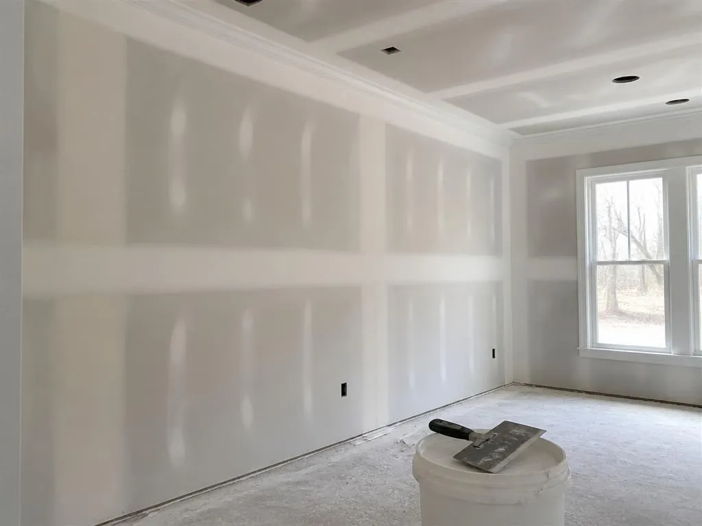 Taped and mudded drywall seams being prepared for paint